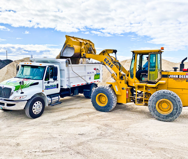 Truck, Loader moving rock fill